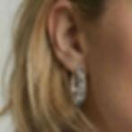 Juno hoop earrings in sterling silver on ear, close-up