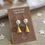 Thumbnail: Metallic Gold Angel Earrings with Silver Wings