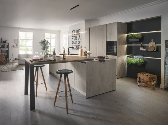 Light grey Schüller kitchen with large island and breakfast bar.