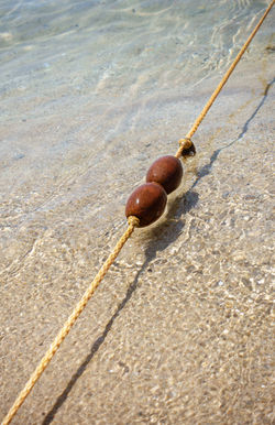 Rope with small buoys in crystal clear water