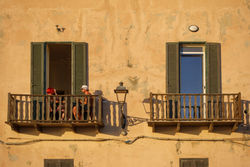 Two people on balcony at sunset