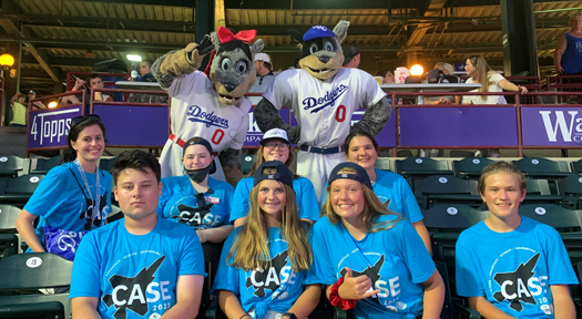 The group poses with team mascots Brooklyn and Brix at an Oklahoma City Dodgers baseball game on July 27.