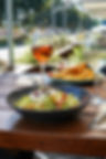 Outdoor lunch with salad, fries and wine