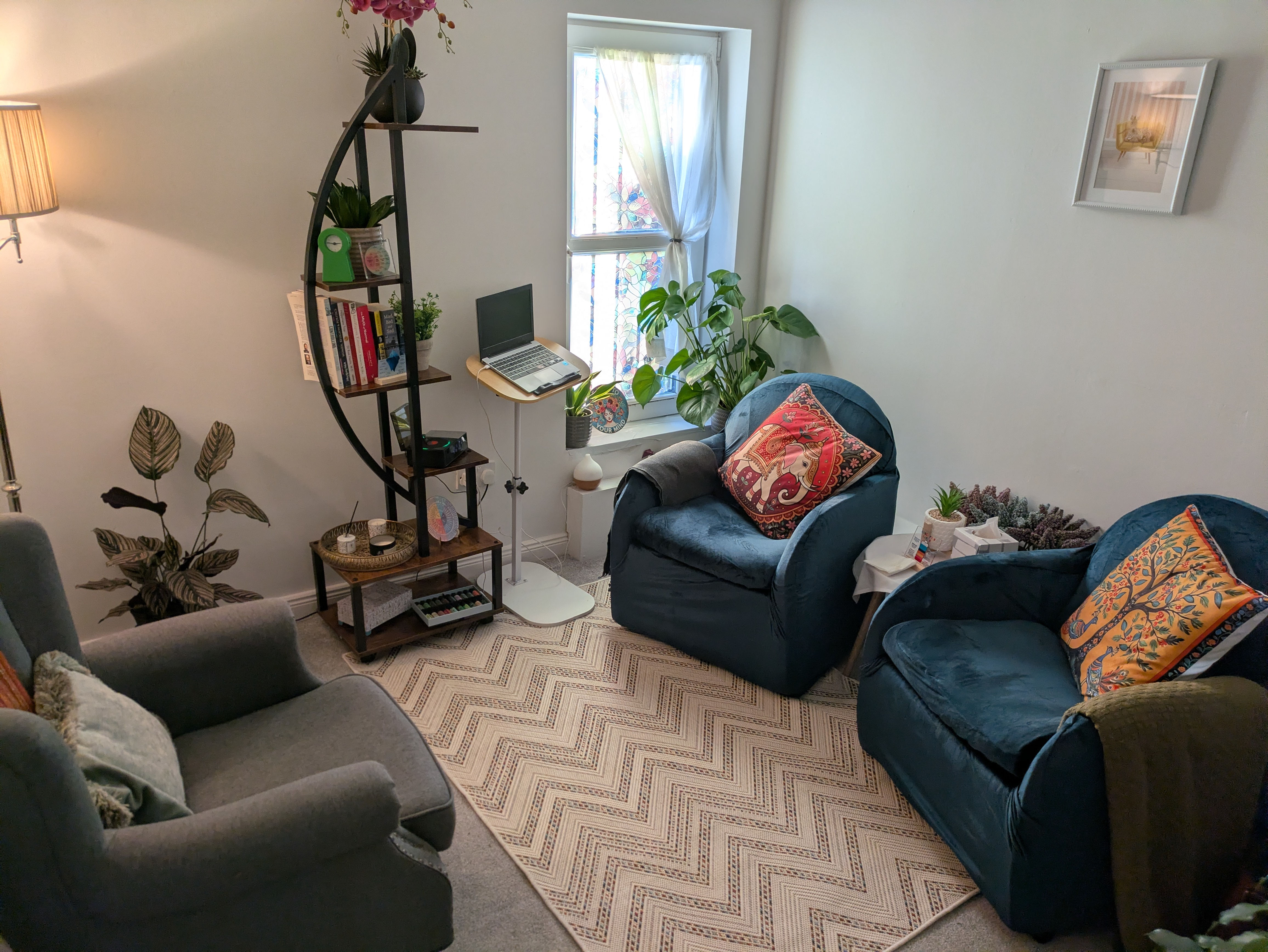 A tranquil counselling room with two comfortable armchairs, a small coffee table, and soft lighting, creating a confidential and calming environment for therapy sessions.