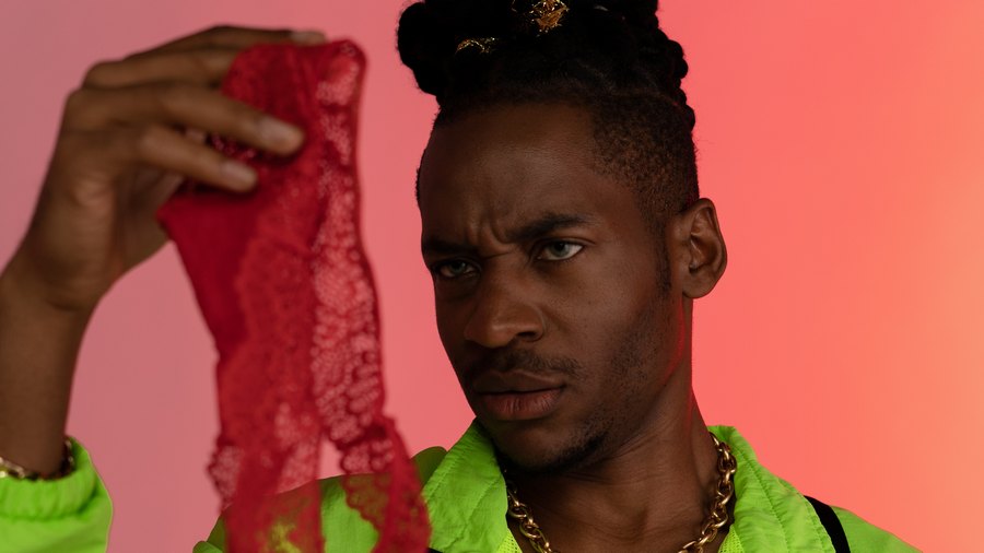 black guy looking at the red sexy lingerie underwear