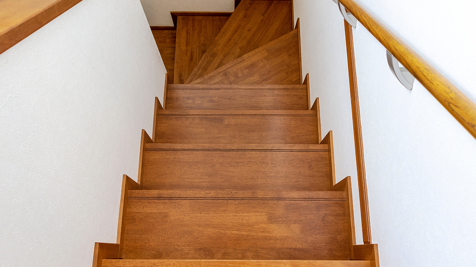 looking down at staircase with gorgeous stained treads and a winding staircase