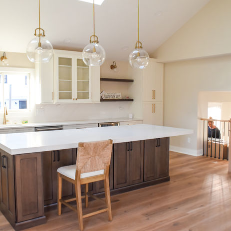 New Kitchen remodel with dark wood island and marble countertop, new cabinetry