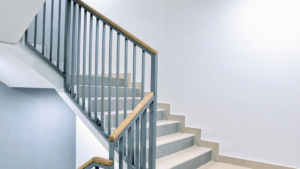 staircase with metal railings and wood on top