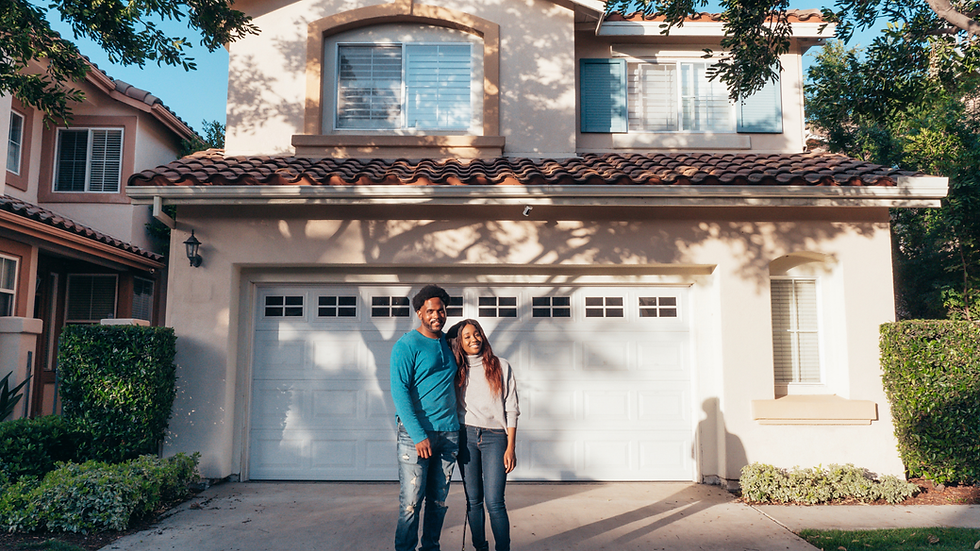 young couple outside a nice suburban home