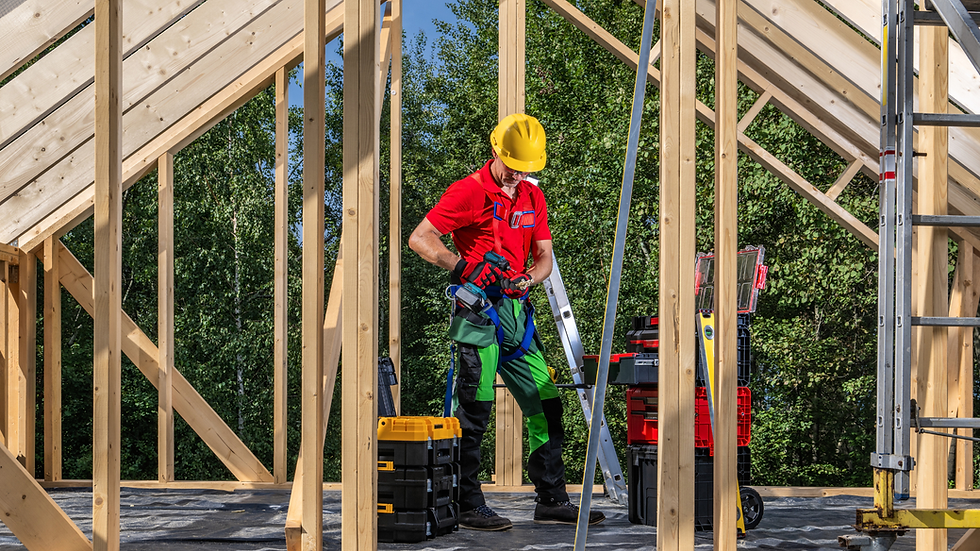 contractor, worker standing the in the middle of a room being built showing just framing