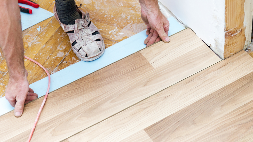 man installing hard wood flooring
