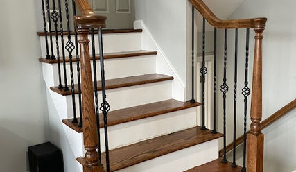 stair railing installation in Bound Brook, New Jersey with wood posts, decorative metal balusters, and volute detail