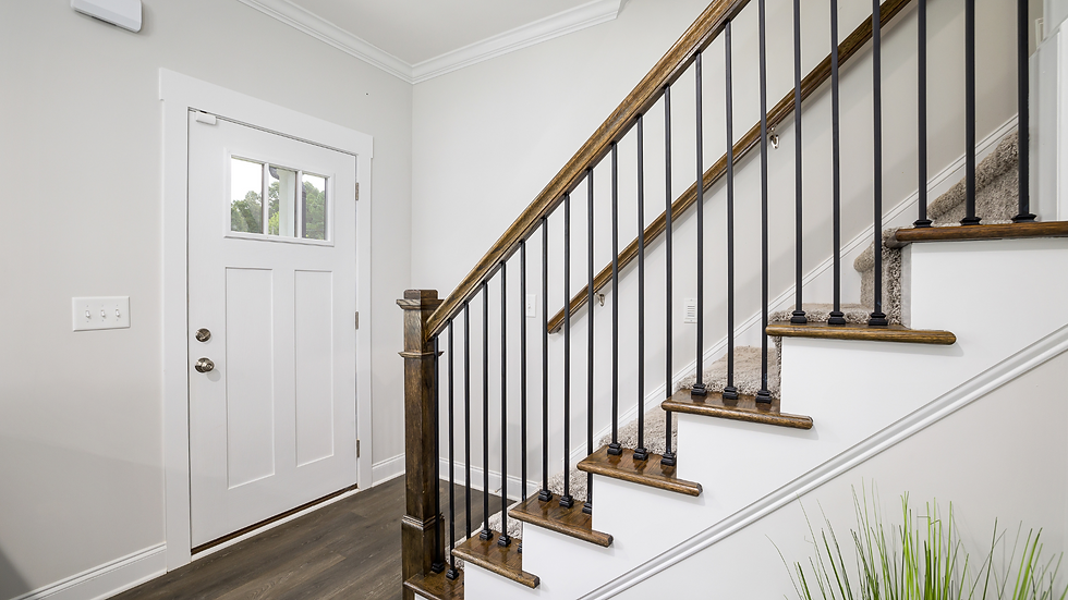 entryway with metal and wood railing as focal point