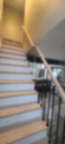 After_ New Red Oak Treads and Primed White Risers with Metal and Wood Rails, installed in