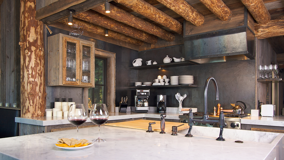 custom kitchen with dark colors, round wood beams and wooden accents