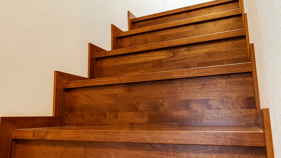 Hardwood staircase with matching trim and baseboards in a Central Florida home