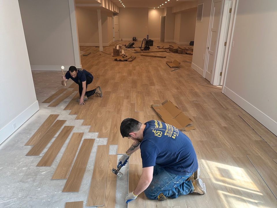 worker, working on installing new wood flooring