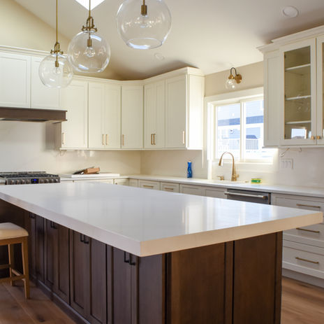 New Kitchen remodel with dark wood island and marble countertop, new cabinetry