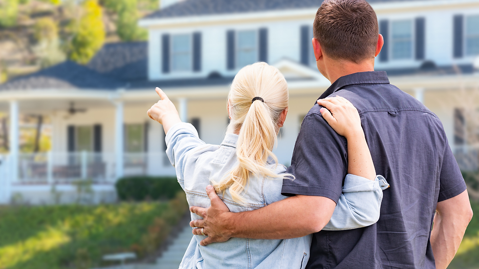 couple standing outside their home comtemplating