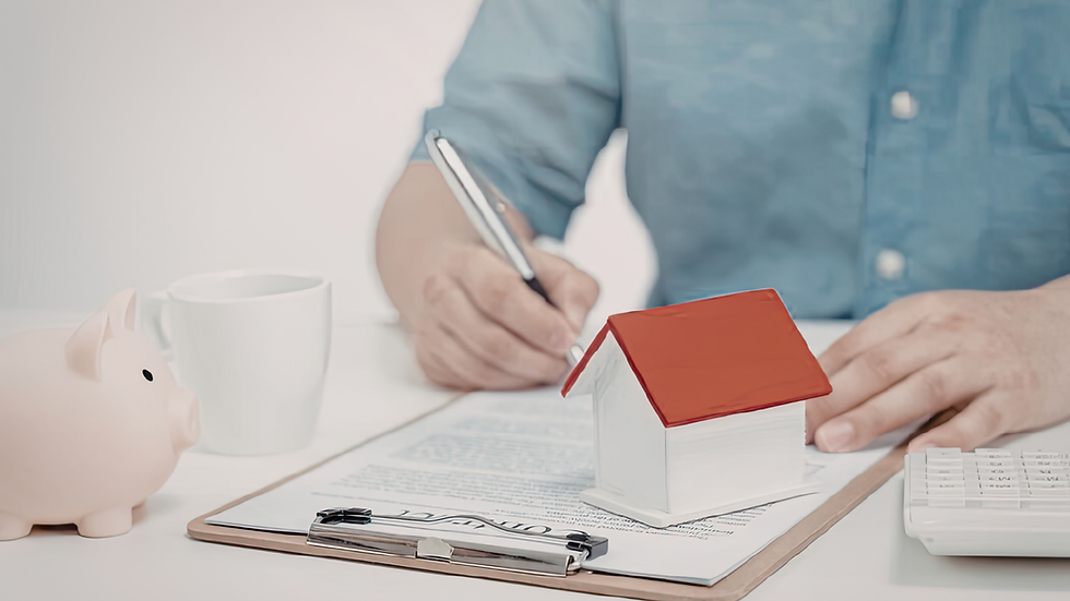 man doing paperwork like budgeting with a ceramic house on top of paperwork