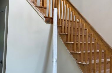 Before photo of 1970s-style wood slat stair railings in Bridgewater, NJ home