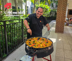 Paella Marinera cooked for a small birthday party at a pool.