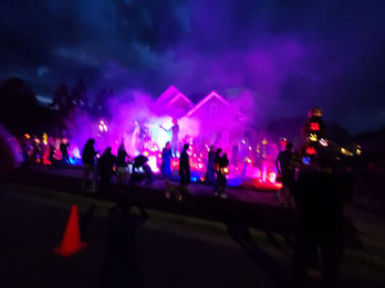 Onlookers lined up at Haunted Halloween House Yard Display