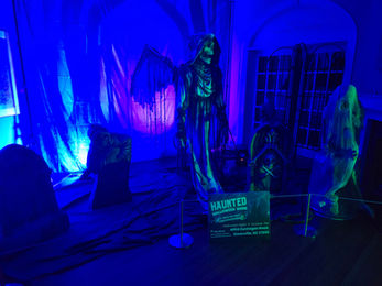 Grim reaper animatronic in cemetery at Haunted Halloween House setup at Greenville Museum of Art