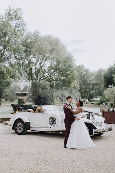 Nelly et Louis posant devant leur somptueuse Excalibur avant leur cérémonie de mariage