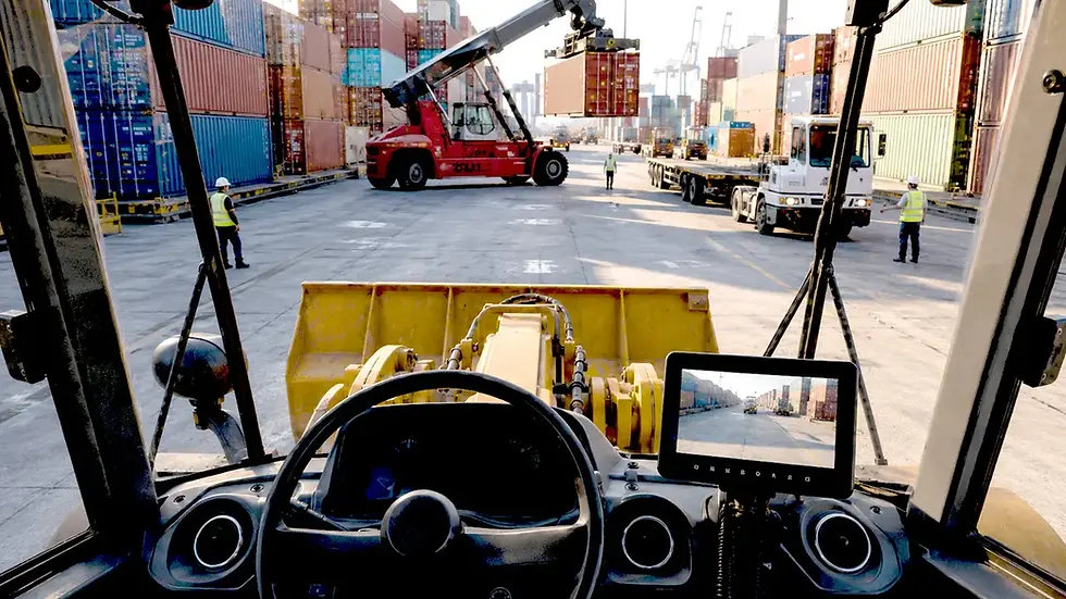 Reach stacker maneuvering between containers where a radar backup camera supports rear proximity awareness