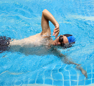 adult man swimming fresstyle in swimming lesson