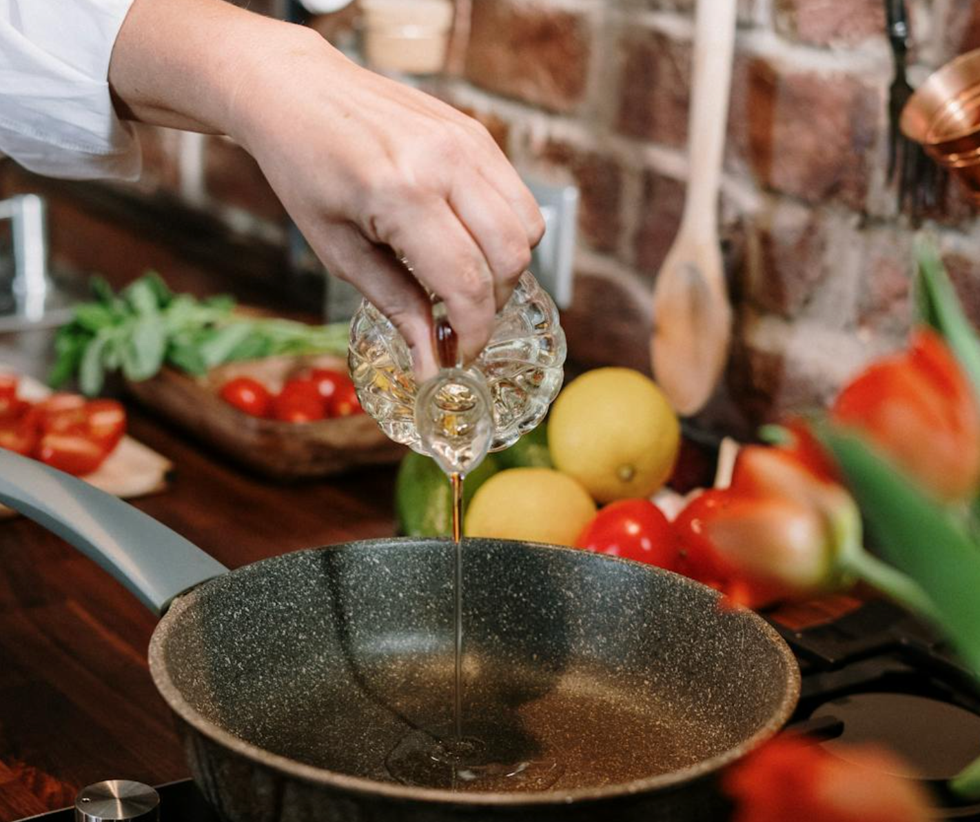 A persons hands are washing vegetables and putting them in a pot to cook