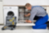 Young Man In Overall With Toolbox Repairing Dishwasher.jpg