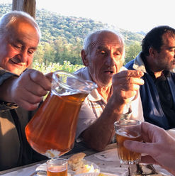 Three men pouring wine and talking
