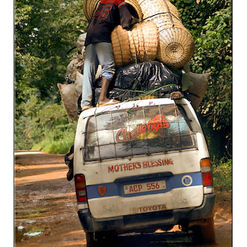 overladen minibus on laterite road