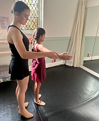 Instructor guiding a young dancer at the barre in the DANCE1 Lindfield studio