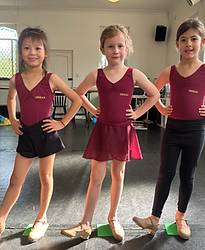 DANCE1 students showing off their Tap shoes wearing their uniform
