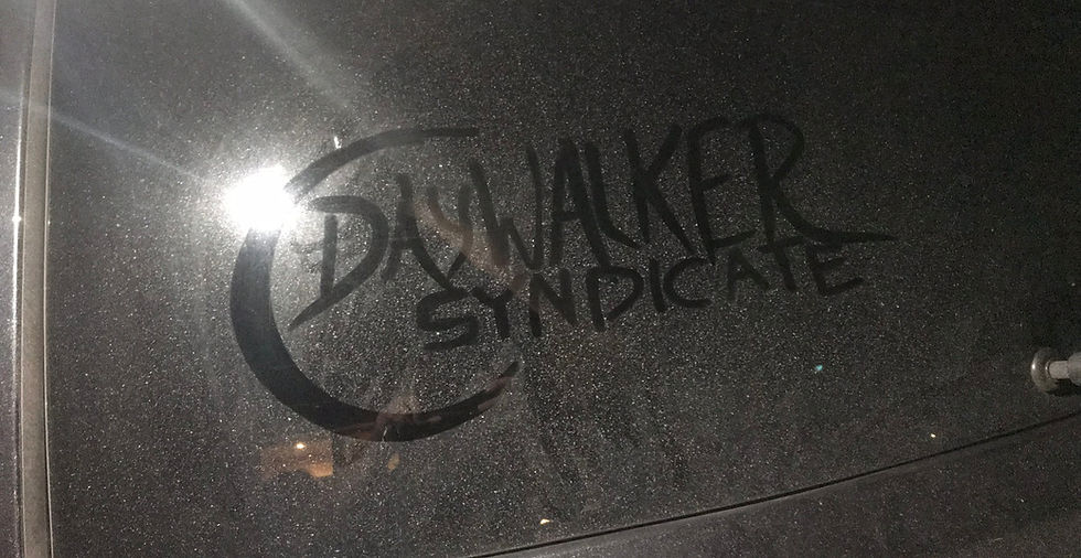 The Daywalker Syndicate logo made by running a finger over a dusty car window to remove dust and create a "relief" of the brand mark.