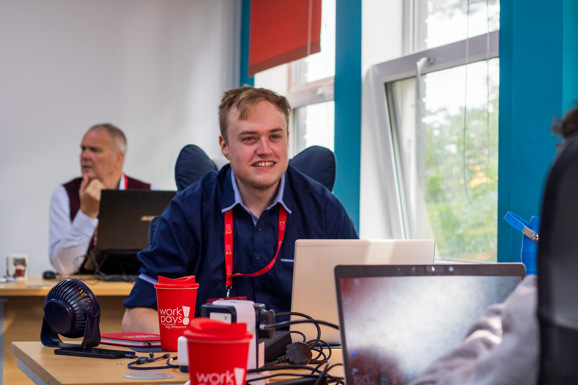 Former P2A learner, Sam Hutchings interacting with Workpays staff as an apprentice.