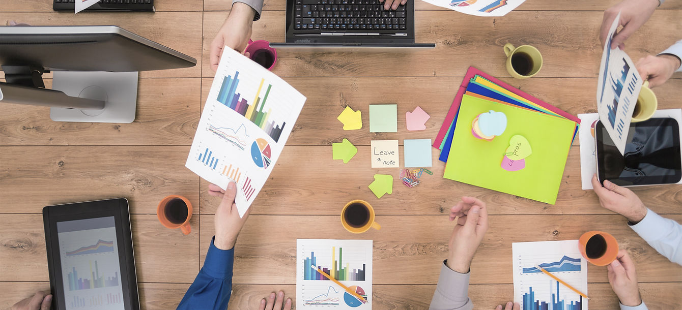 Desk with Team Members Working