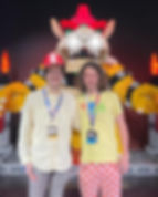 Sam & Kuyper smiling in front of Lego Bowser