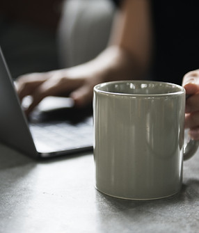 Beverage Mug and a Laptop