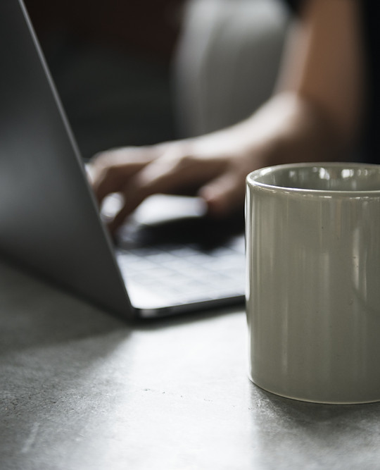 Beverage Mug and a Laptop