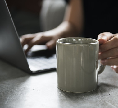 Beverage Mug and a Laptop