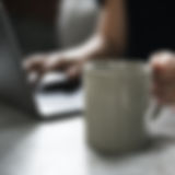 Beverage Mug and a Laptop