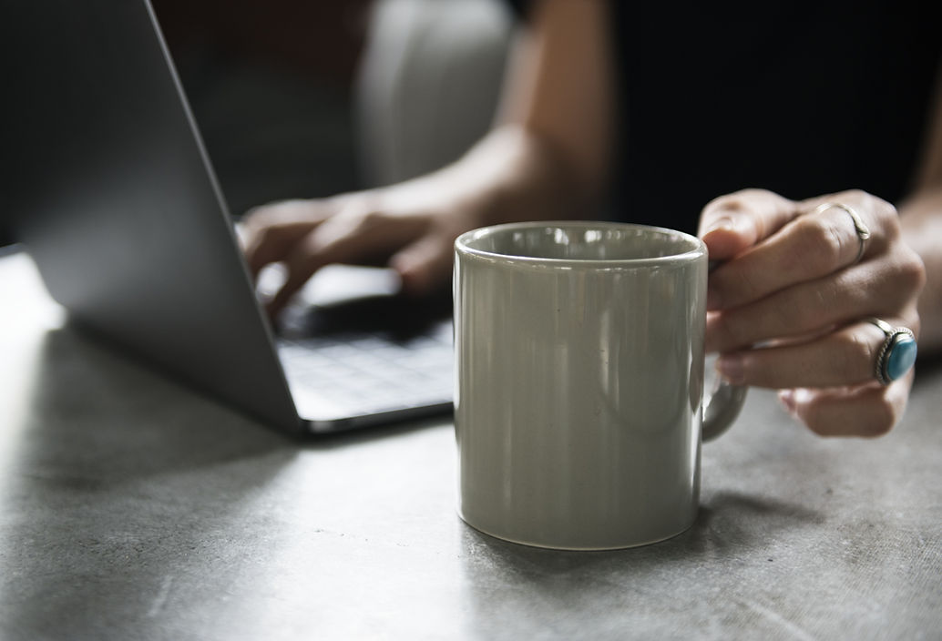 Beverage Mug and a Laptop