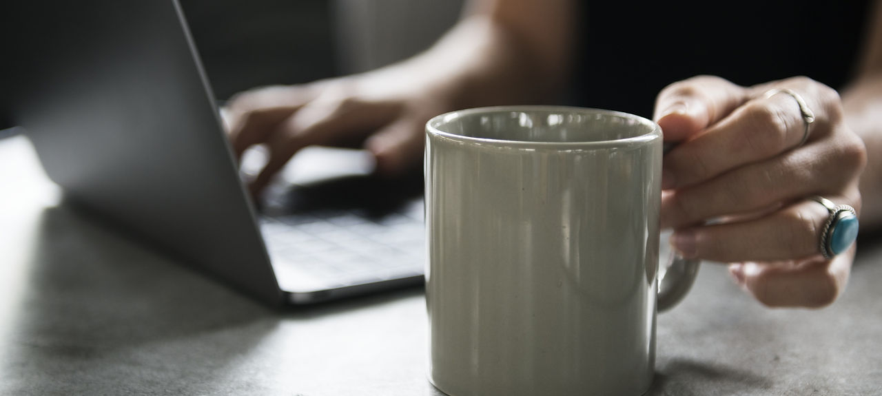 Beverage Mug and a Laptop