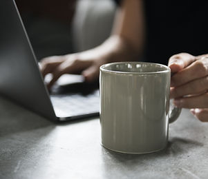 Beverage Mug and a Laptop