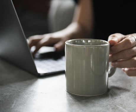 Beverage Mug and a Laptop
