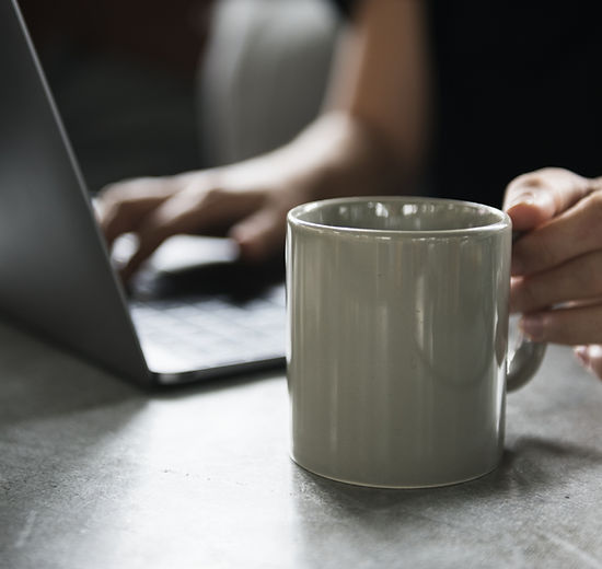 Beverage Mug and a Laptop